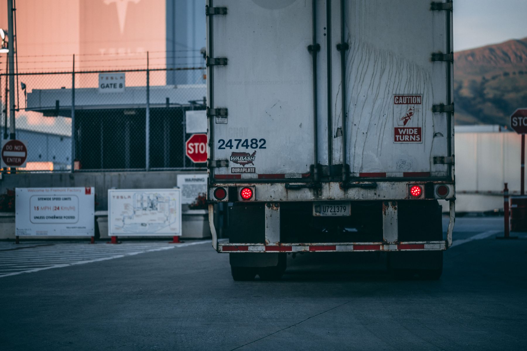 Rear of a dry freight trailer at an industrial facility entrance